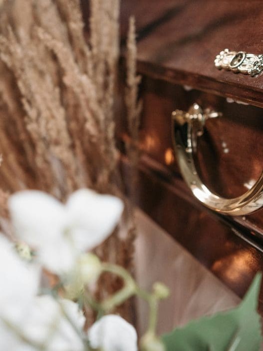 funeral casket with flowers on top