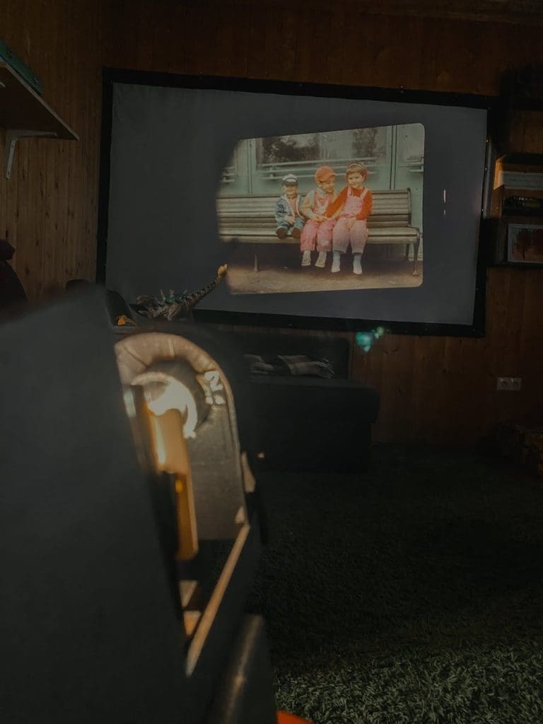 black flat screen tv turned on displaying man in black suit