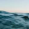 body of water under blue and white skies